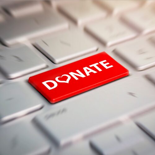 a red donate button on a keyboard