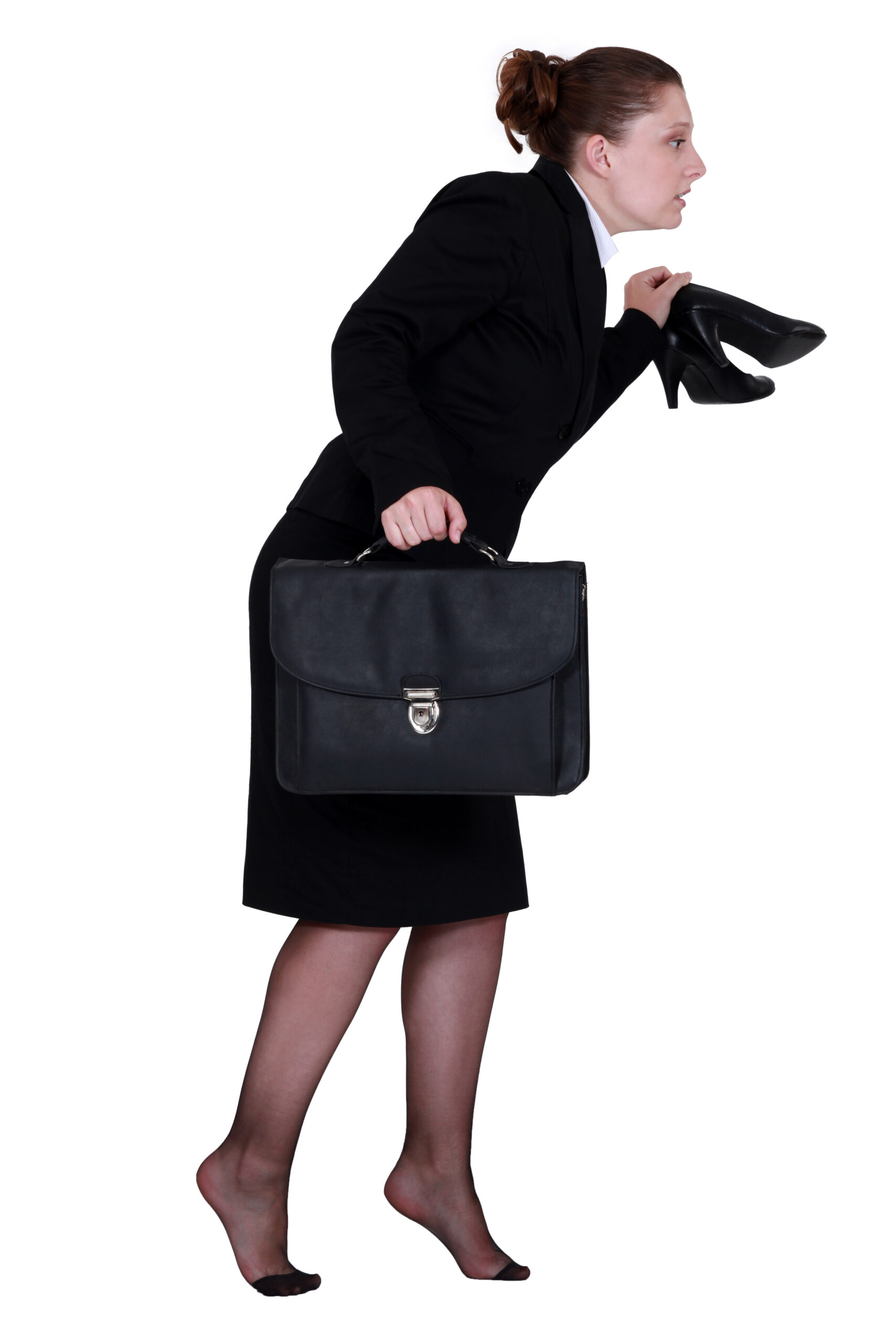 a woman sneaking away with her shoes in one hand and a brief case in the other hand